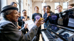 students around piano