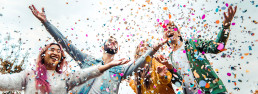 Diverse students celebrating while confetti rains down